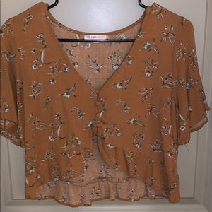 Dark yellow/gold crop top with floral patterns